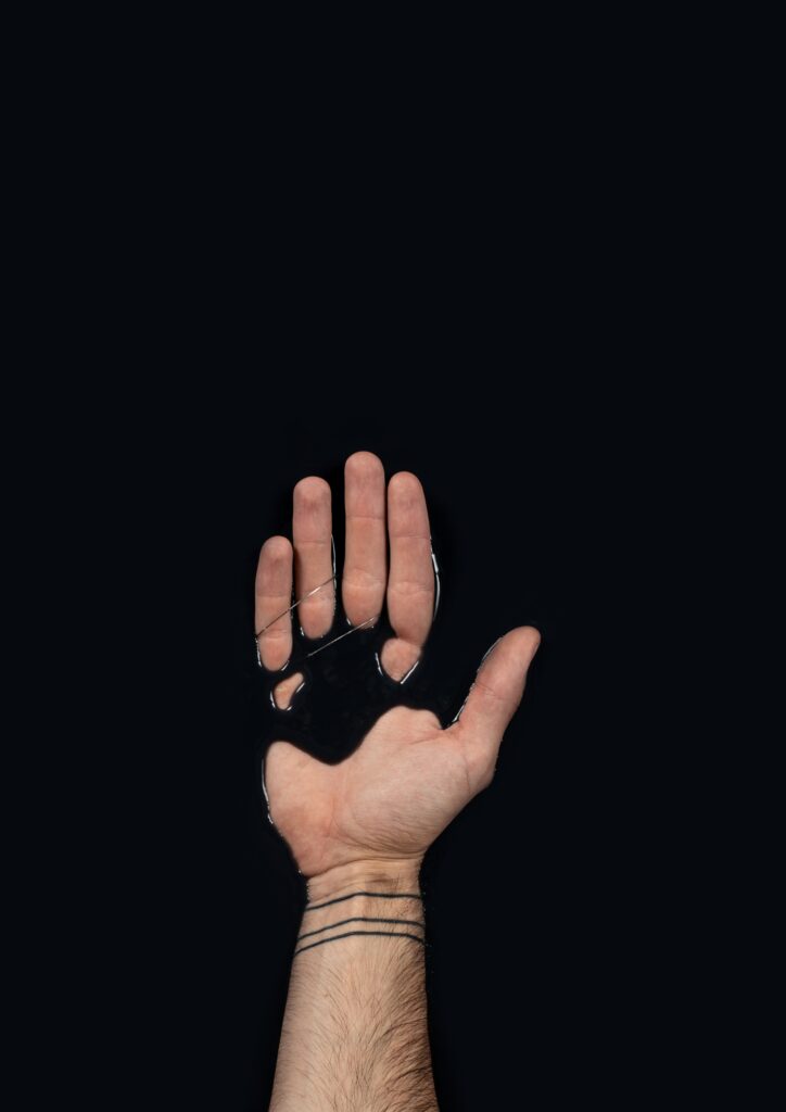 Minimalist 4768x6740 Wallpaper: Hand in Glossy Black Liquid