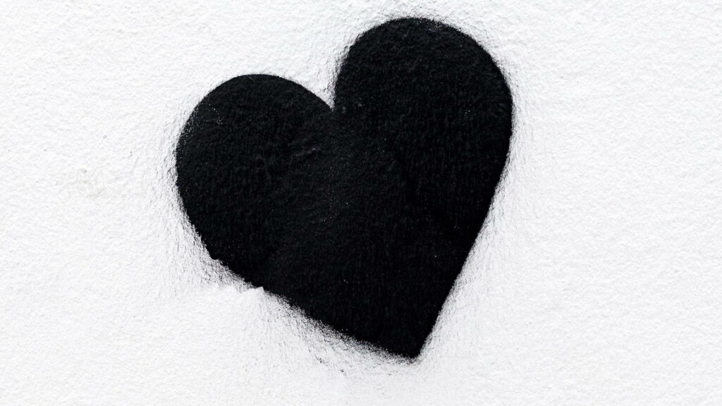 Bold Black Heart Minimalistic Wallpaper on White Textured Background