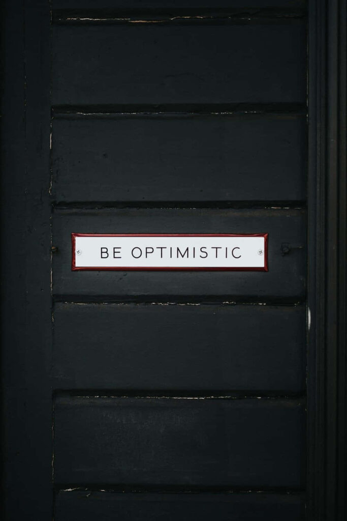 Minimalist Black Wallpaper: 'Be Optimistic' Motivational Quote