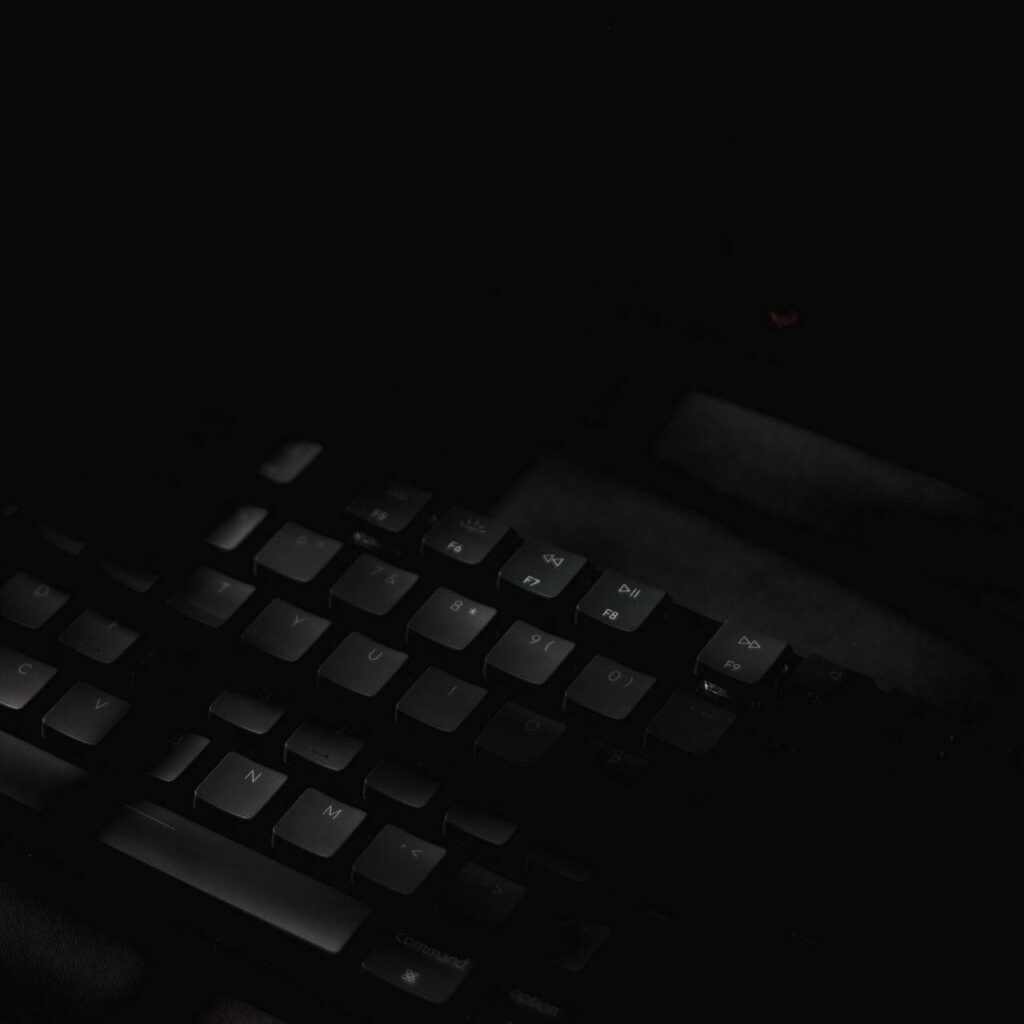 Minimalist Dark Matte Wallpaper: Sleek Keyboard in Low Light