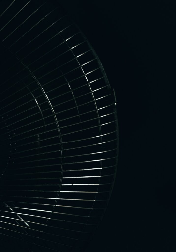 Minimalist Dark Wallpaper: Sleek Metal Grill with Light & Shadow Effects