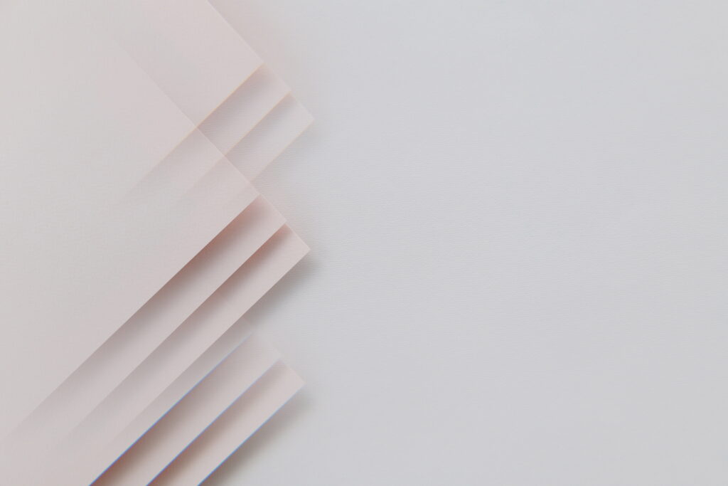 Minimalistic Elegance: A Crisp White Paper Resting on a Table – High-Resolution 8K Wallpaper