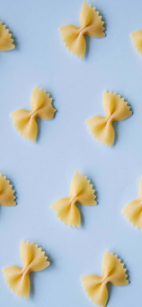 Minimalistic Farfalle Pasta Wallpaper on Soft Blue Background
