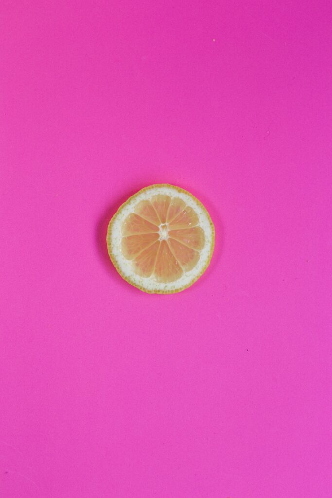 Minimalistic Lemon Wallpaper: Vibrant Pink Background Contrast