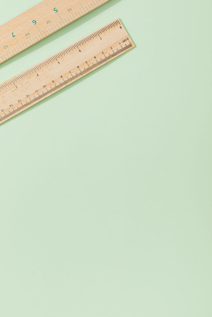 Minimalist Pastel Green Wallpaper with Diagonal Wooden Rulers
