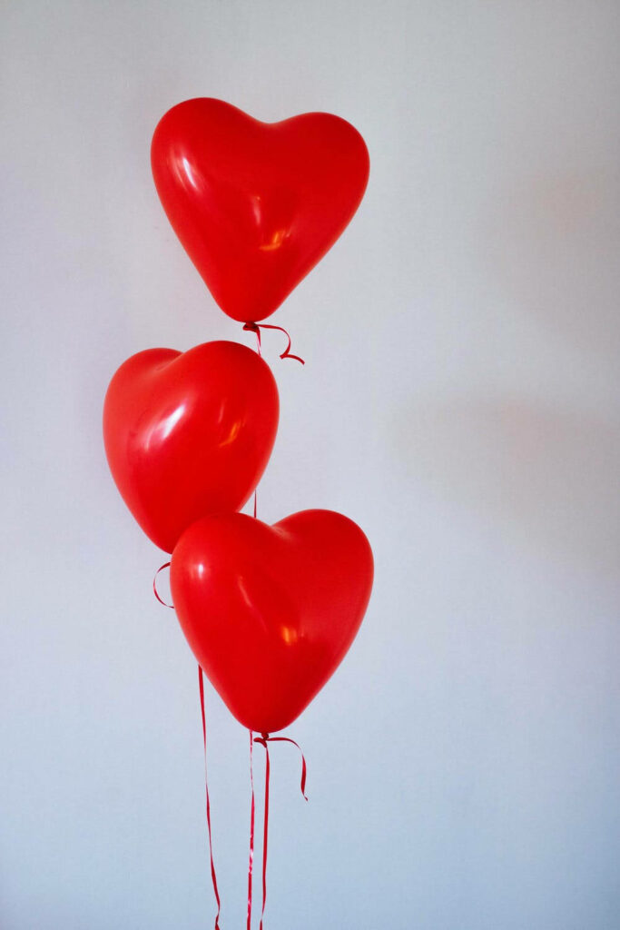 Minimalist Red Heart Balloons Wallpaper: Romantic Aesthetic Background