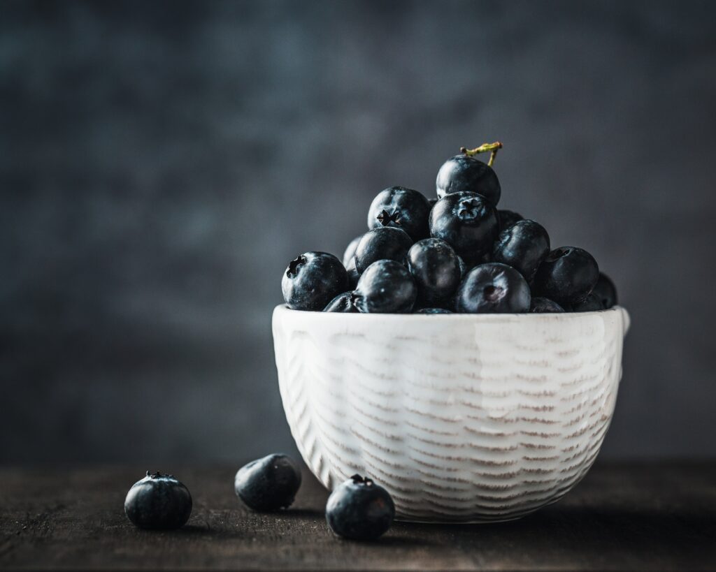 Minimalist Wallpaper: Ceramic Bowl with Fresh Blueberries Background