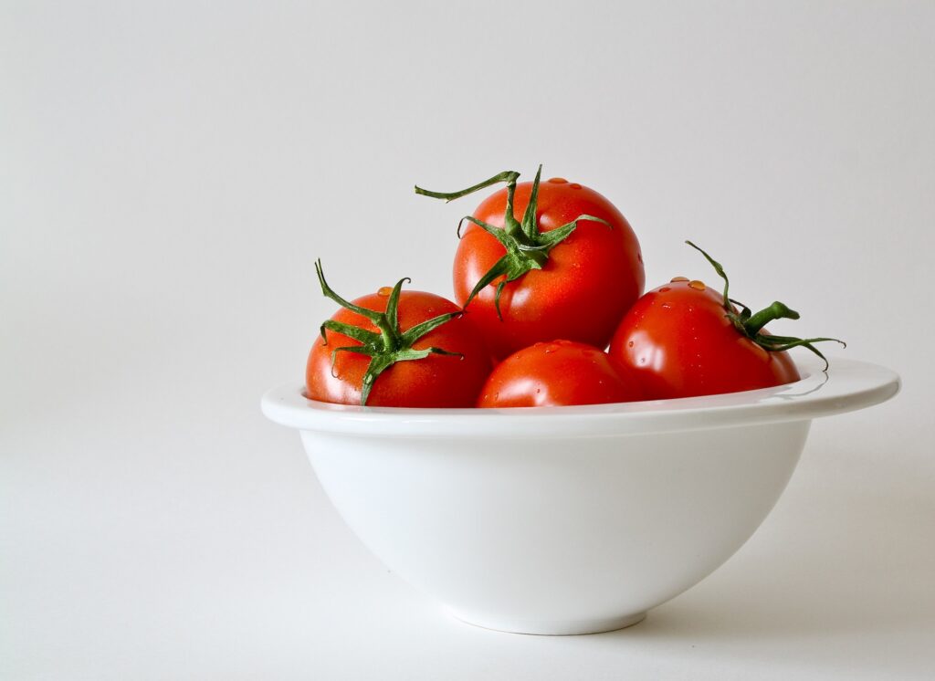 Minimalistic Wallpaper: Fresh Red Tomatoes in White Bowl
