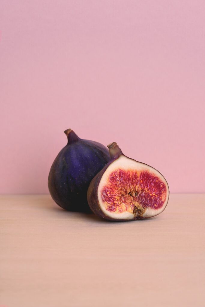 Minimalist Figs Wallpaper: Ripe Purple Figs on Soft Pink Background