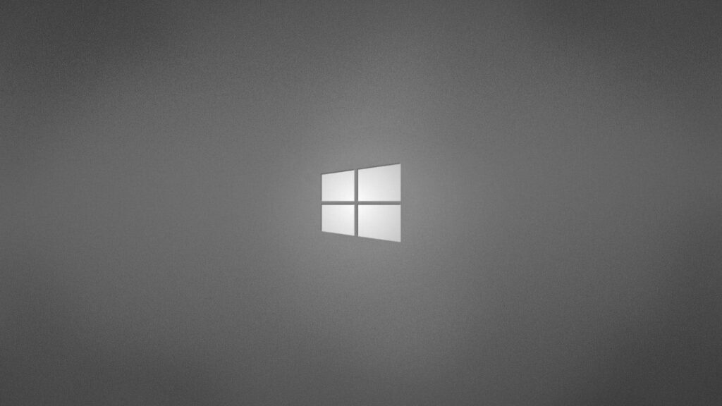 Minimalist glowing white Windows logo on dark grey background modern desktop wallpaper design