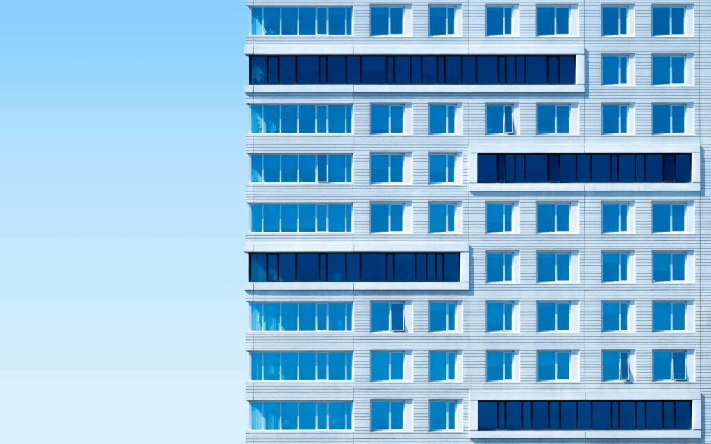 Minimalist Architecture: A Glimpse of Crisp White Box Amidst a Serene Blue Sky Wallpaper