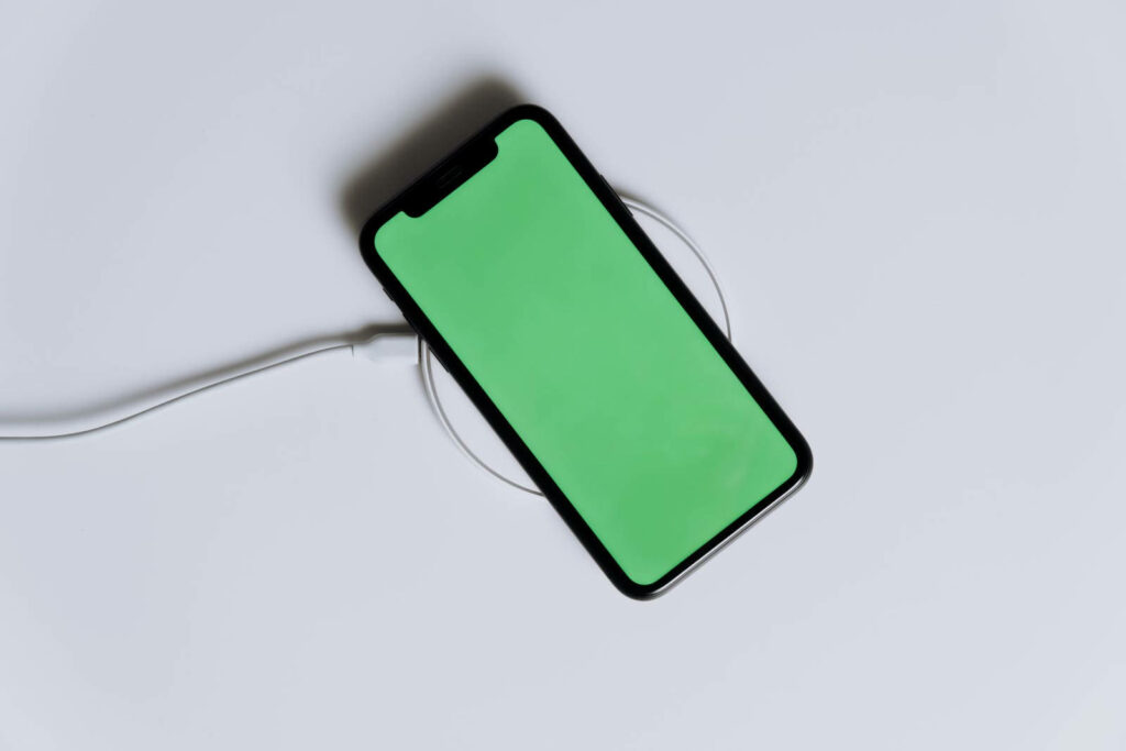 Minimalistic iPhone Green Screen Wallpaper on White Surface