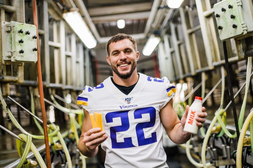 Minnesota Vikings Harrison Smith in jersey holding cheese sticks and milk in rustic dairy parlor Wallpaper