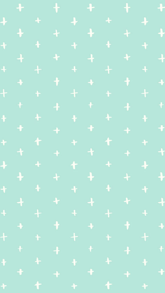 Celestial Serenity: Whimsical Mint Green Background Adorned with White Starbursts Wallpaper