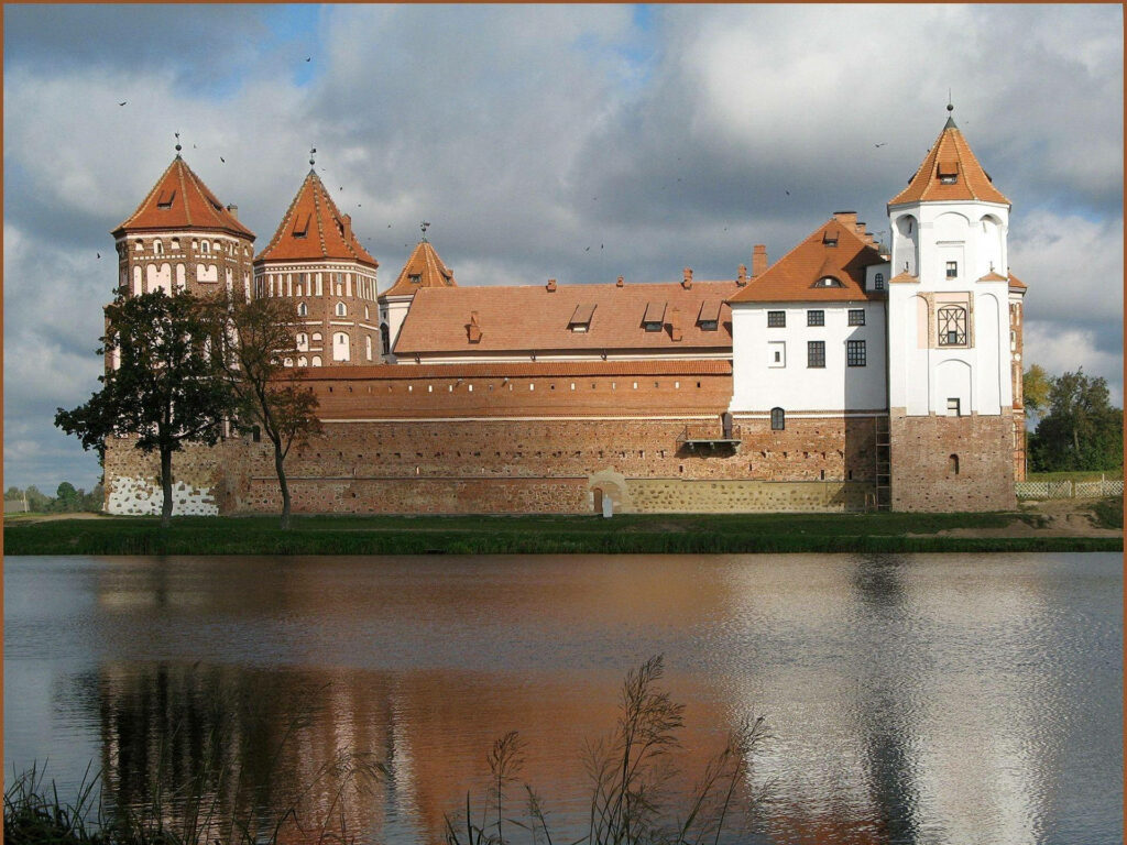 Mir Castle Belarus historic brick castle reflected in calm water under dramatic cloudy sky wallpaper