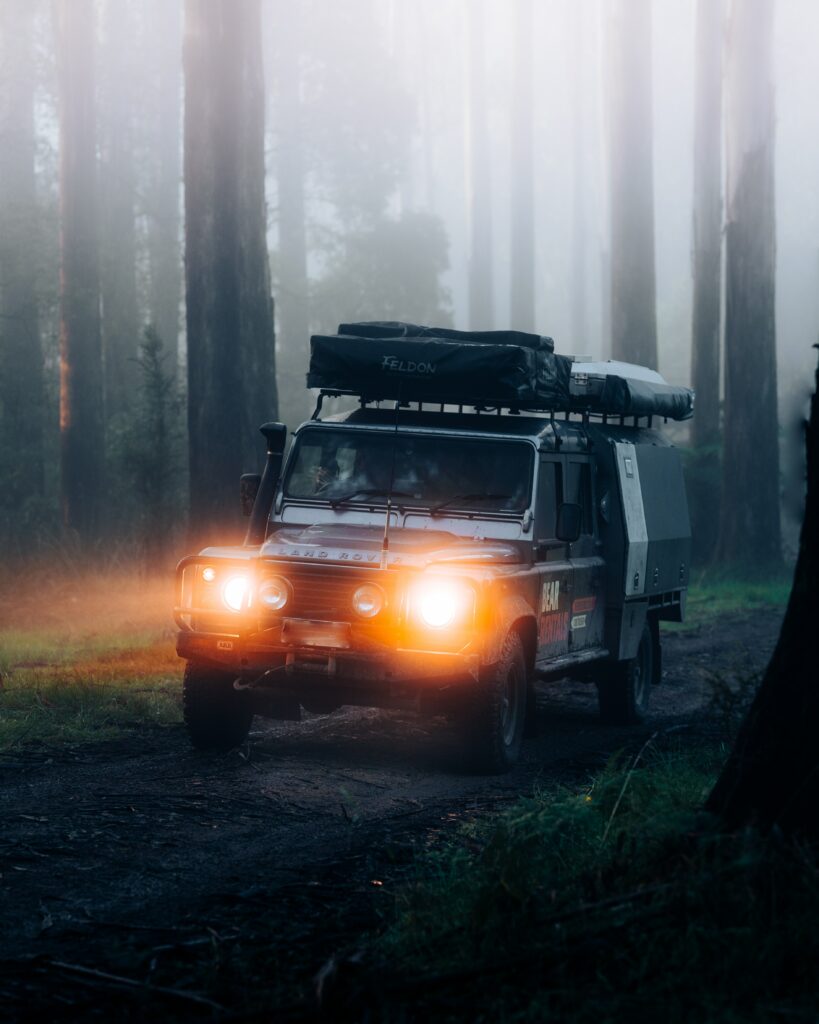 Land Rover Defender in Misty Forest: Adventure & Exploration Background Wallpaper