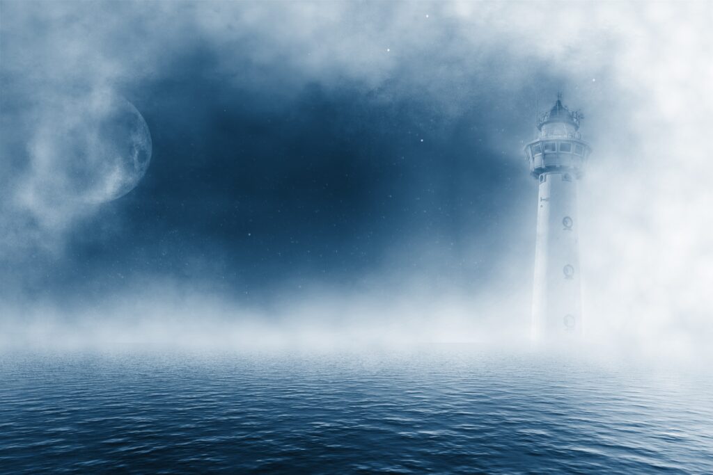 Solitary lighthouse glowing in foggy moonlight over calm sea with moody blue atmospheric sky Wallpaper