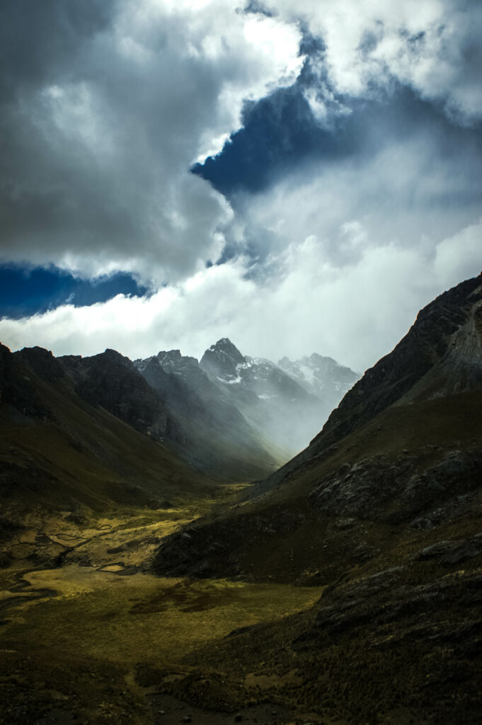 Dramatic mountain wallpaper with rugged rocks steep slopes misty fog and drifting clouds background