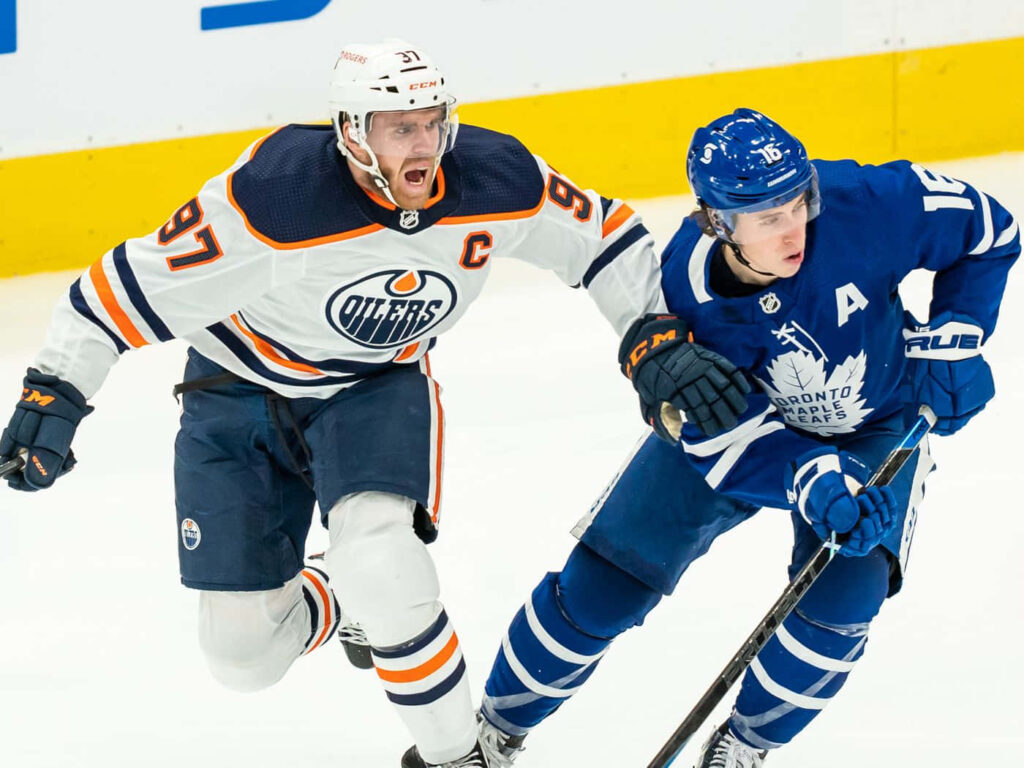 Mitchell Marner and Connor McDavid face off in vibrant Toronto Maple Leafs vs Edmonton Oilers hockey wallpaper