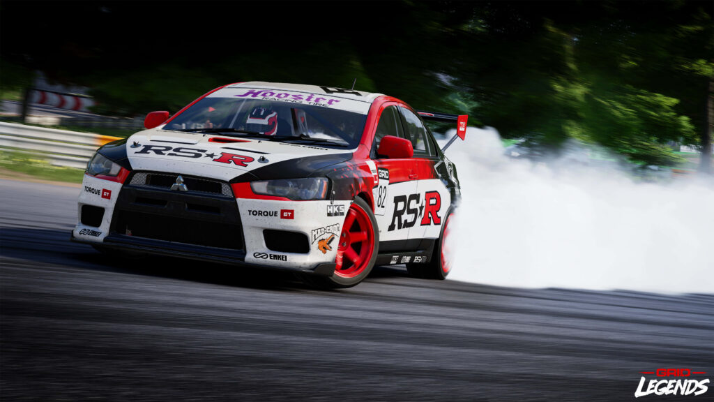 Mitsubishi Evo rally car drifting fast on racetrack with smoke and GRID Legends branding 8K Wallpaper