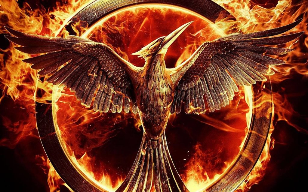 Mockingjay symbol from The Hunger Games with metallic wings and fiery intense flame background Wallpaper