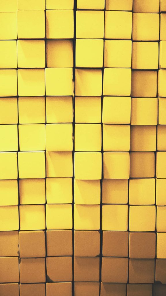 Abstract yellow 3D square tile grid wallpaper with soft shadows and modern geometric design background