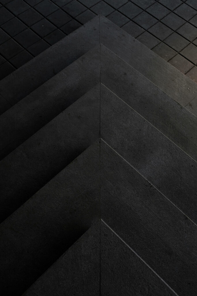 Modern Abstract Concrete Wallpaper: Sleek Dark Triangular Design