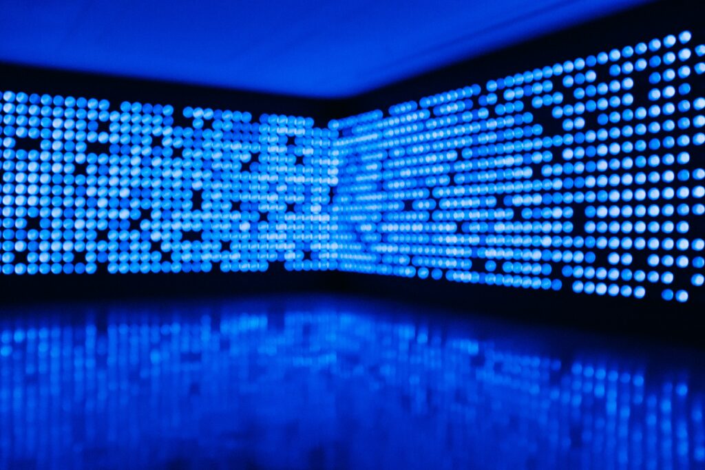 Modern Abstract Wallpaper: Striking Blue Dots on Dark Background