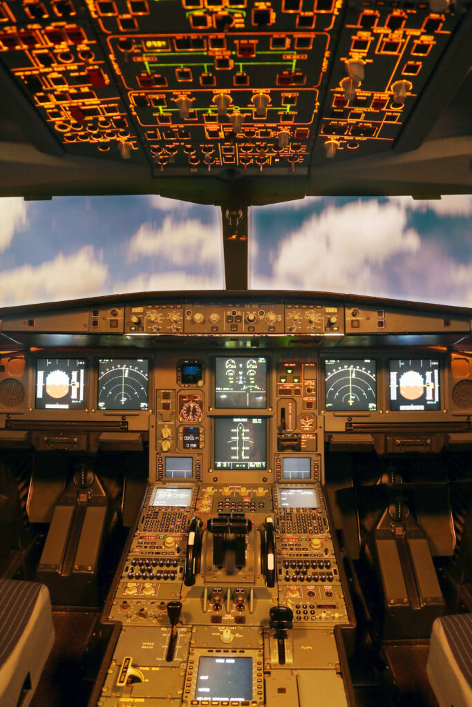 Modern airplane cockpit with illuminated controls digital displays vibrant aviation technology background Wallpaper