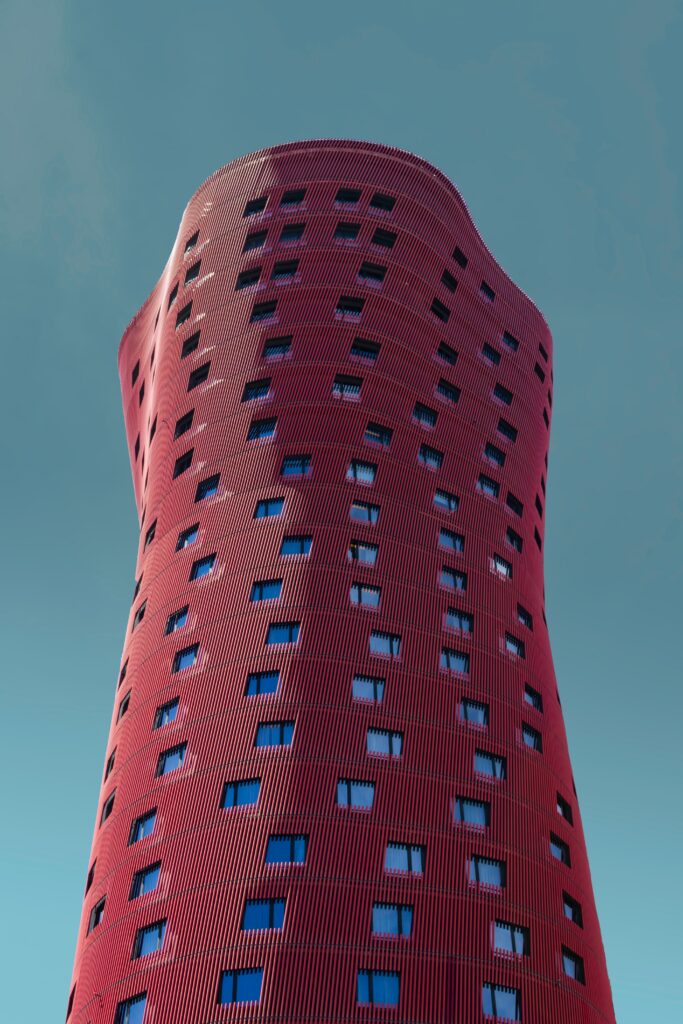Modern Architectural Wallpaper: Bold Red Facade & Clear Blue Sky