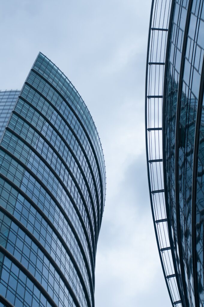 Modern Architectural Wallpaper: Sleek Curved Facades & Soft Sky Reflections