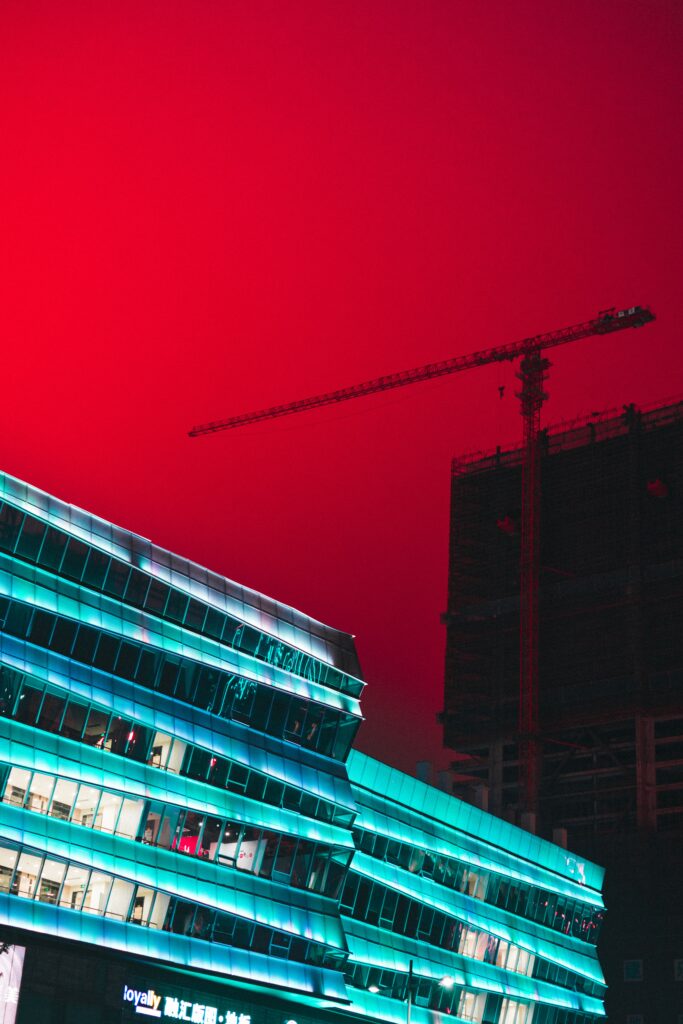 Bold Urban Wallpaper: Modern Architecture & Green-Lit Building Contrast