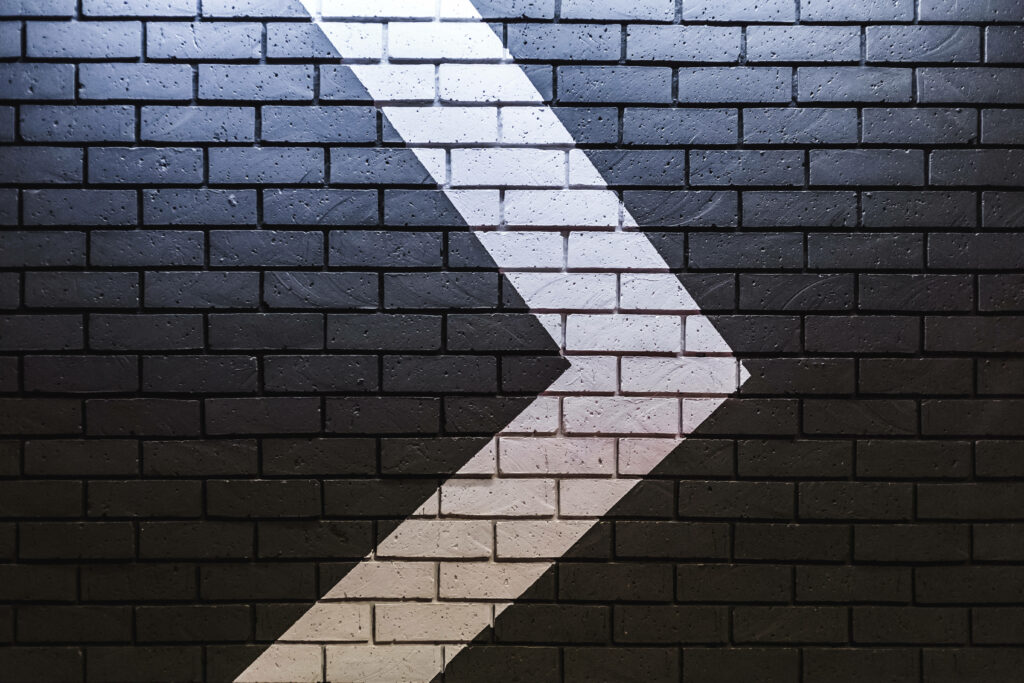 Brick Wall Chic: Pointing the Way with Arrow Wallpaper