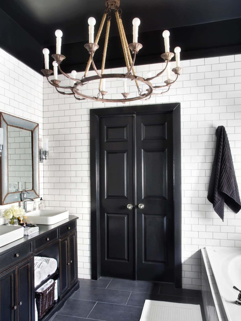 Modern bathroom with white subway tiles black ceiling double doors and rustic rope chandelier Wallpaper