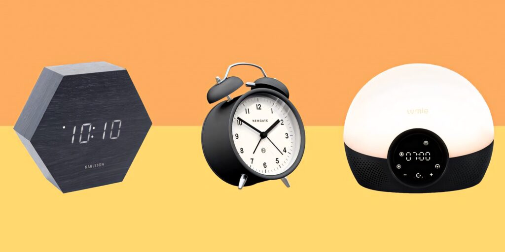 Three modern bedside alarm clocks digital hexagonal analog and sunrise simulation on minimal background Wallpaper