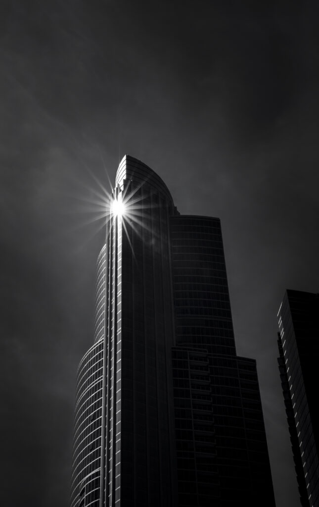 Striking Black-and-White Skyscraper Wallpaper with Dramatic Sunlight
