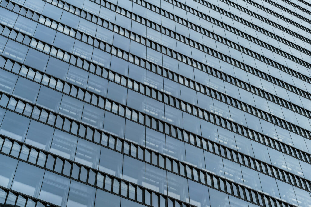 Sleek Modern Building Facade Wallpaper with Reflective Glass Design