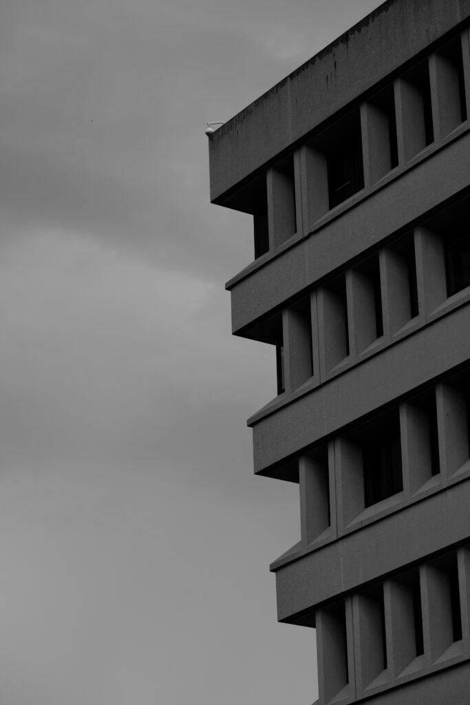 Modern Building Monochrome Wallpaper: Geometric Design & Cloudy Sky