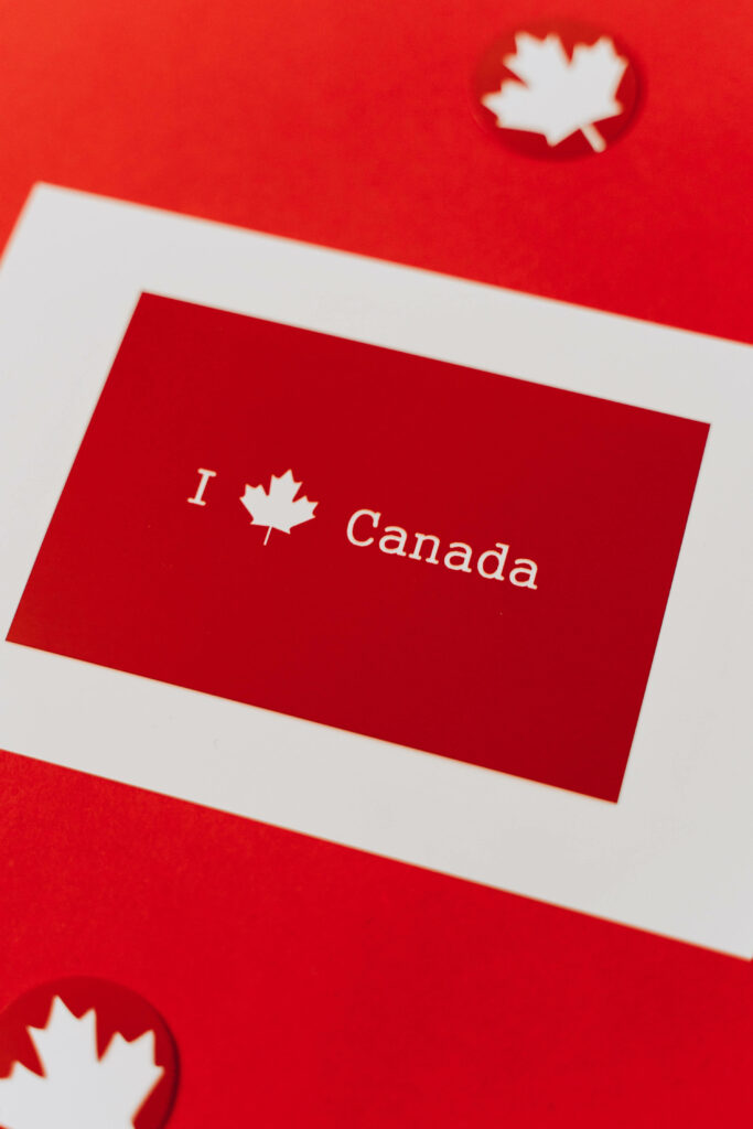 Bold red wallpaper with white frames and Canadian maple leaves expressing national pride