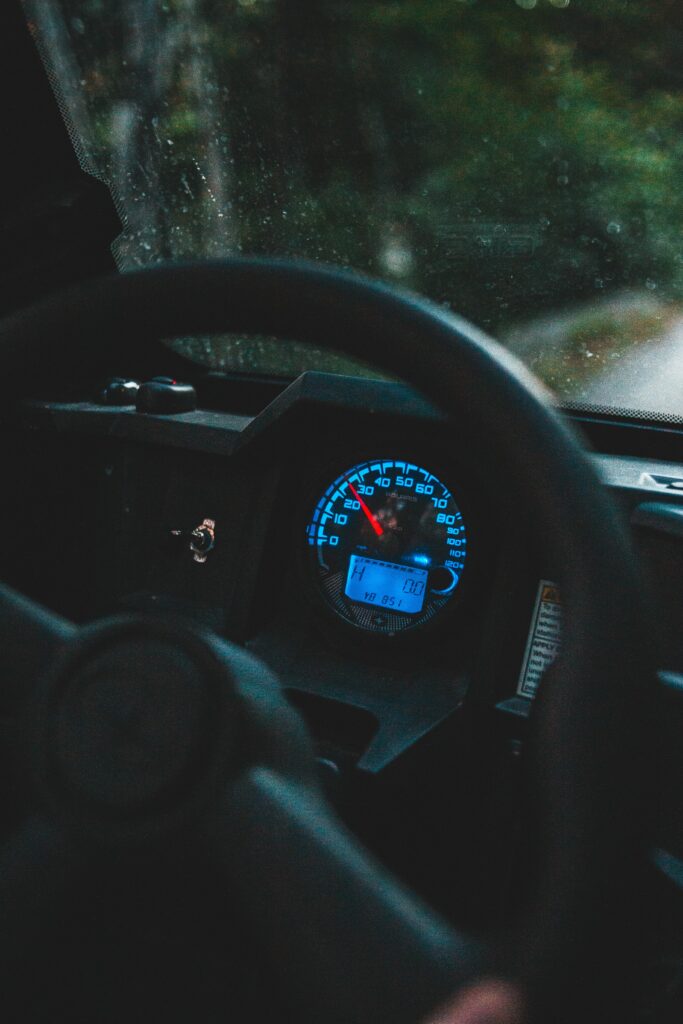High-Tech Car Interior: Illuminated Steering Wheel & Speedometer Wallpaper