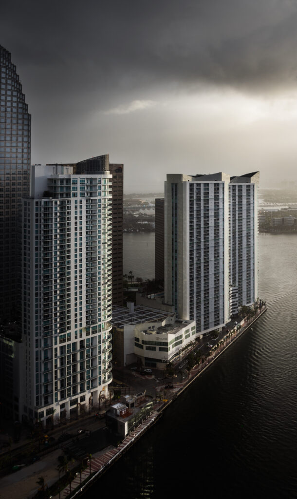 Modern Cityscape Wallpaper: Sleek Buildings & Calm River Background
