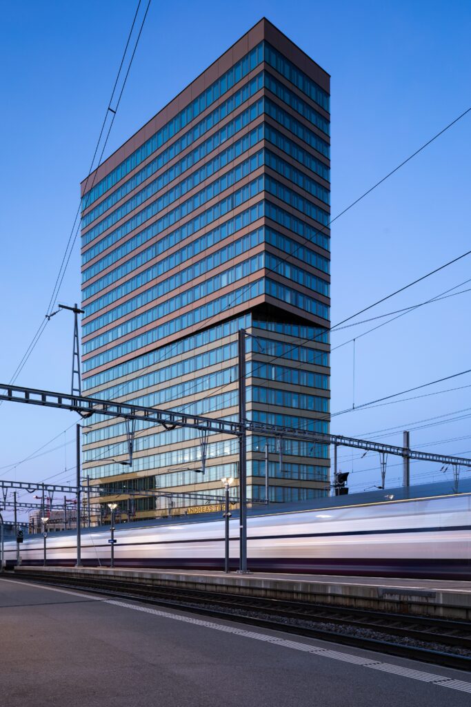Dynamic Modern Cityscape Wallpaper: Sleek Building & Speeding Train