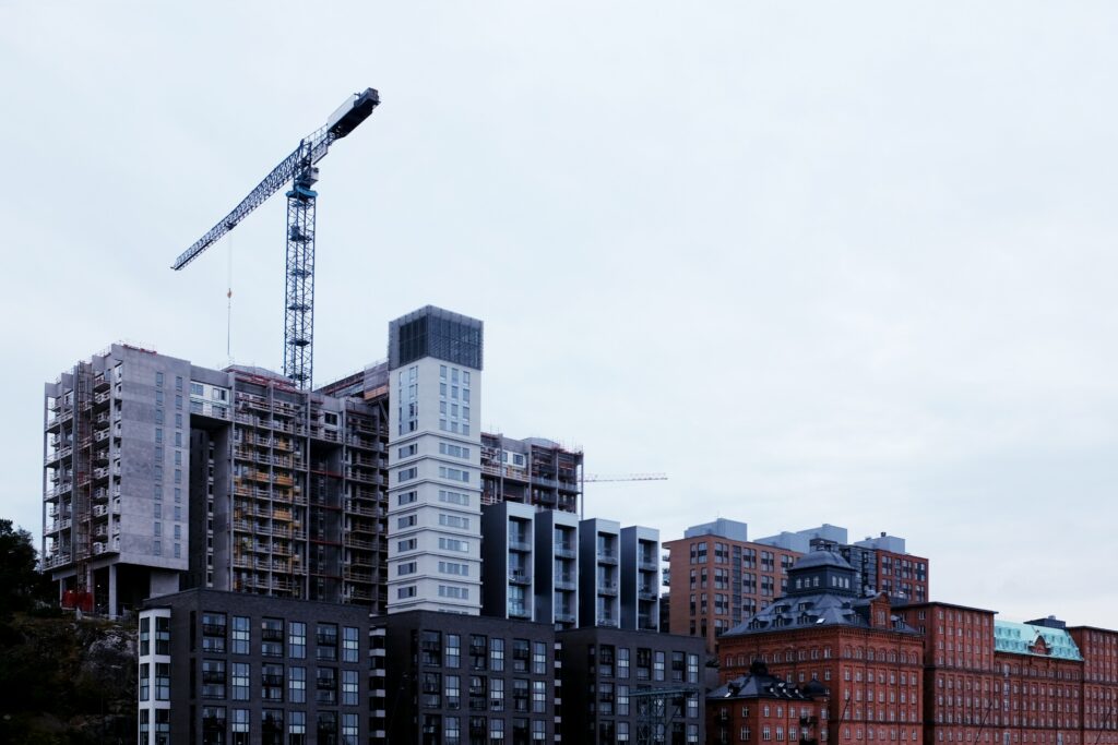 Urban Construction Wallpaper: Modern Cityscape with Crane Background