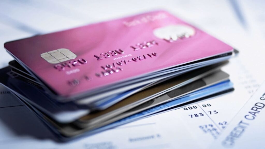 Stack of colorful credit cards on financial documents showing modern payment convenience Wallpaper