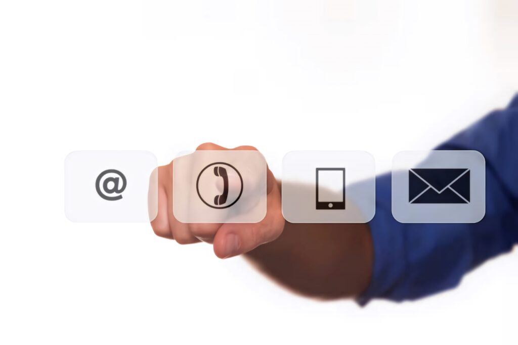 Hand pointing at floating contact icons email phone smartphone envelope modern communication wallpaper