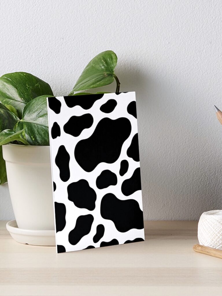 Bold cow print wallpaper with irregular black spots on white for modern farmhouse decor