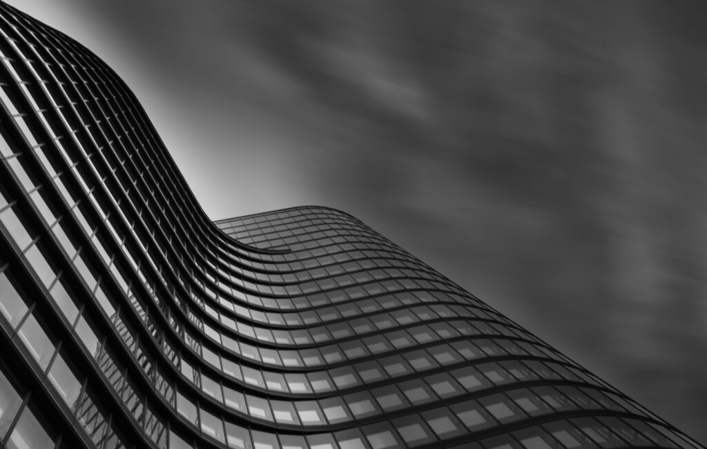 Modern Curved Building Wallpaper: Sleek Black & White Design