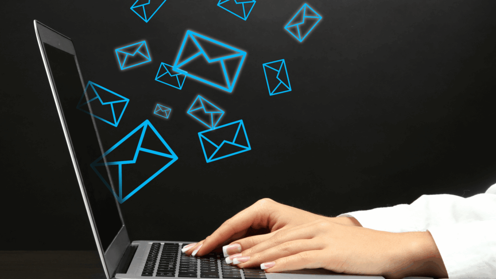 Person typing on laptop with glowing blue email icons symbolizing digital communication wallpaper