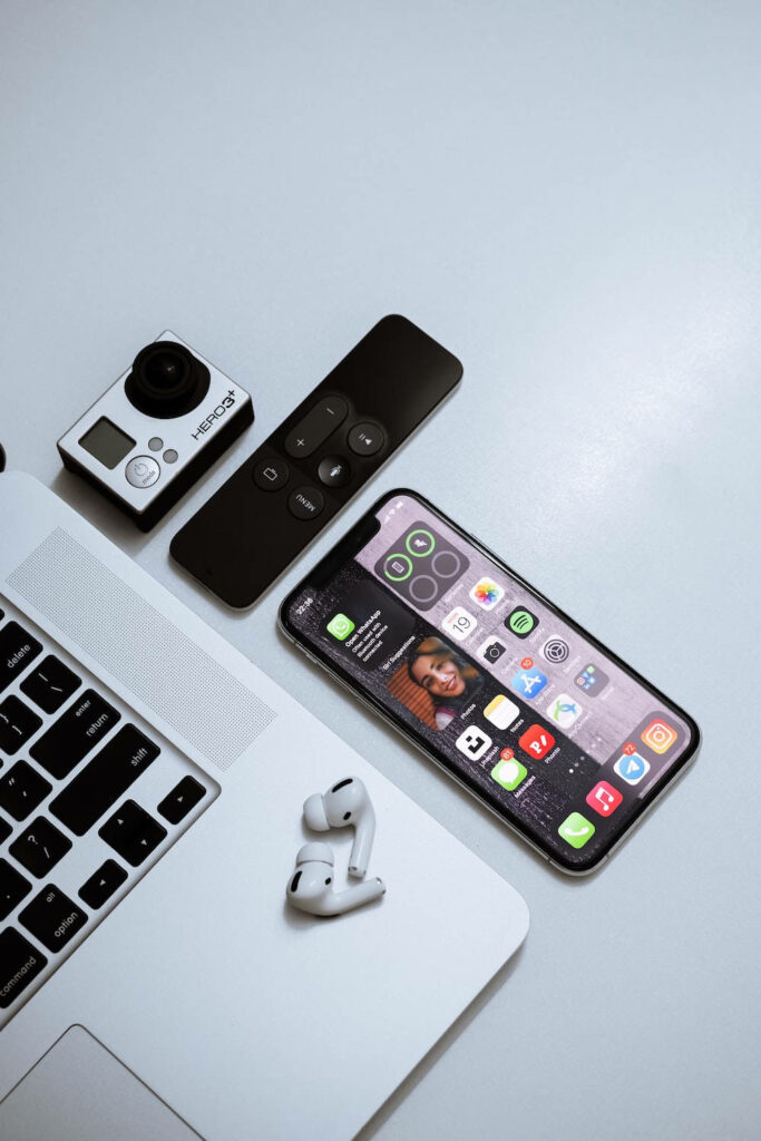 Sleek Modern Tech Setup: iPhone, MacBook, AirPods & GoPro Wallpaper