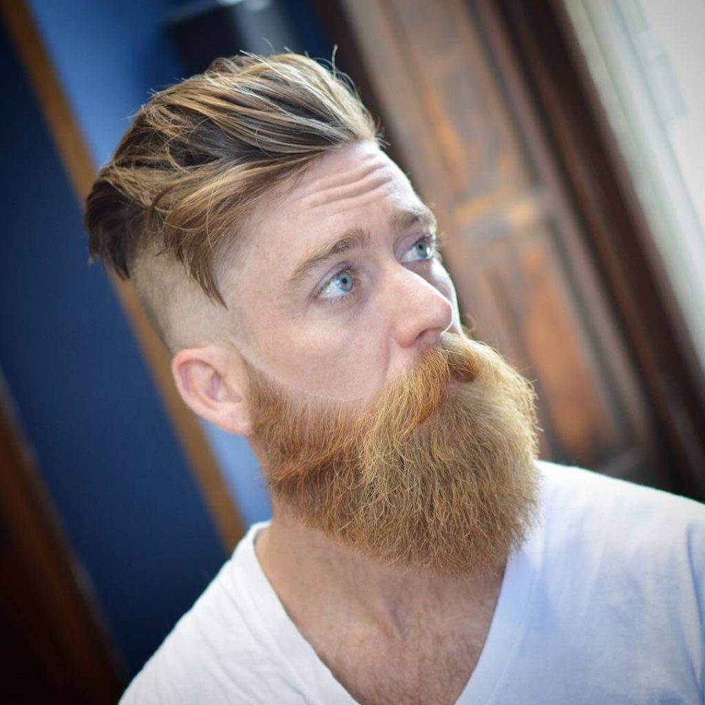 Professional portrait of man with textured undercut and thick ginger beard in soft natural light Wallpaper